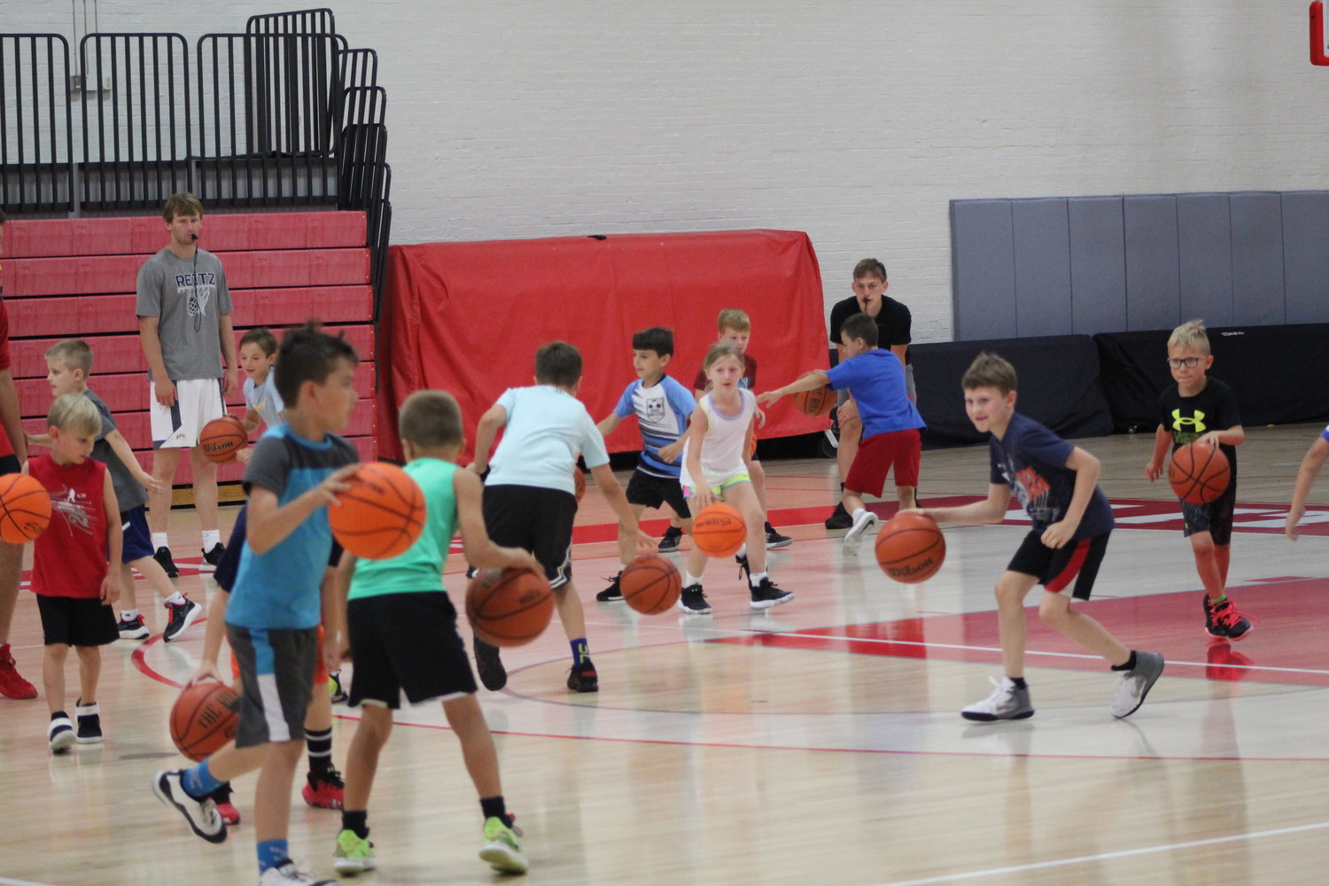 The campers practice their dribbling skills during a drill.